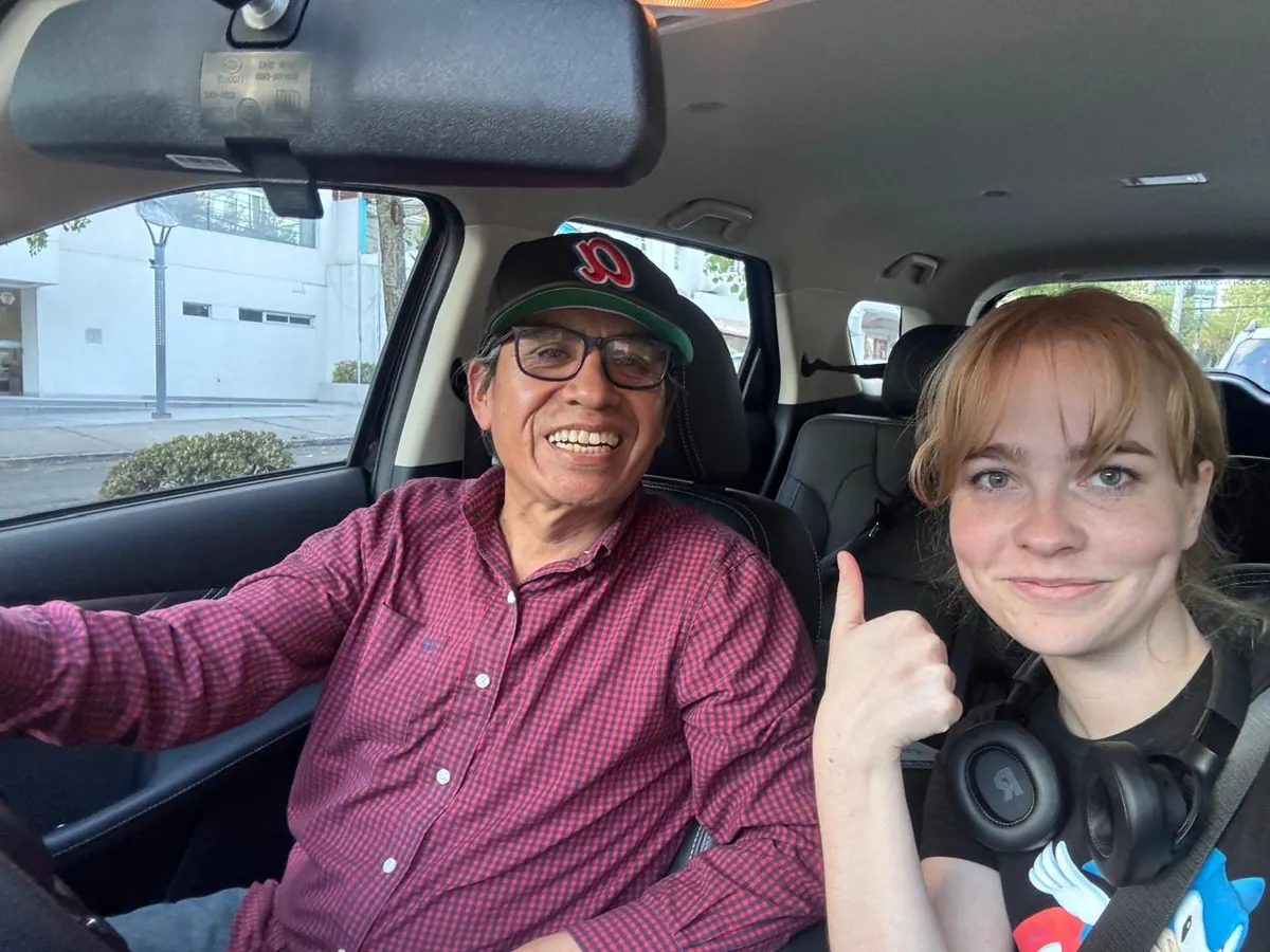 Juan Carlos and a smiling traveler inside the SUV